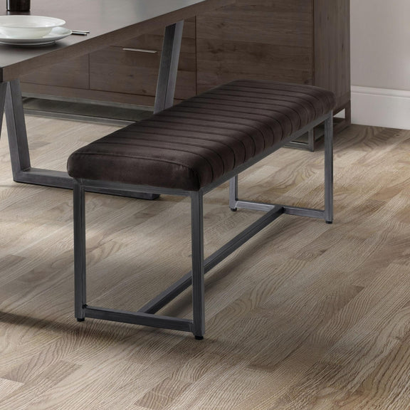 Dining bench with dark cushion on a wooden floor