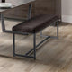 Dining bench with dark cushion on a wooden floor