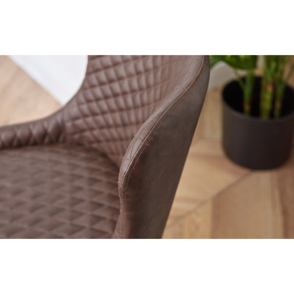 Brown textured chair with a plant on a wooden floor