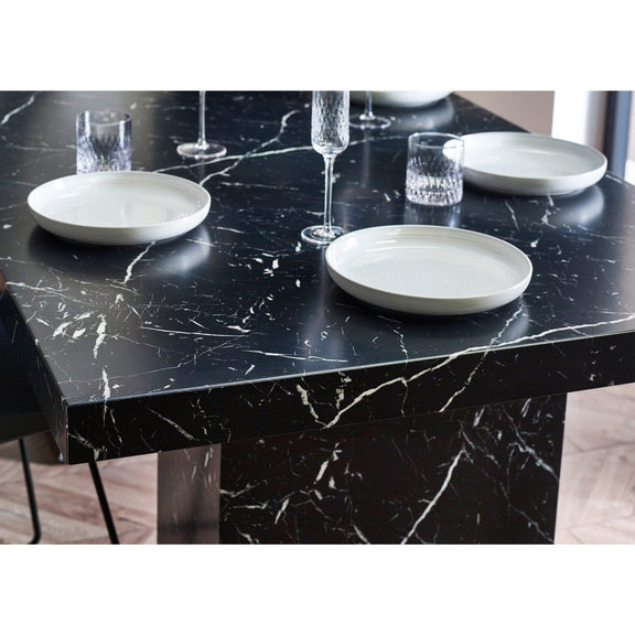 Black marble table with white plates and glasses