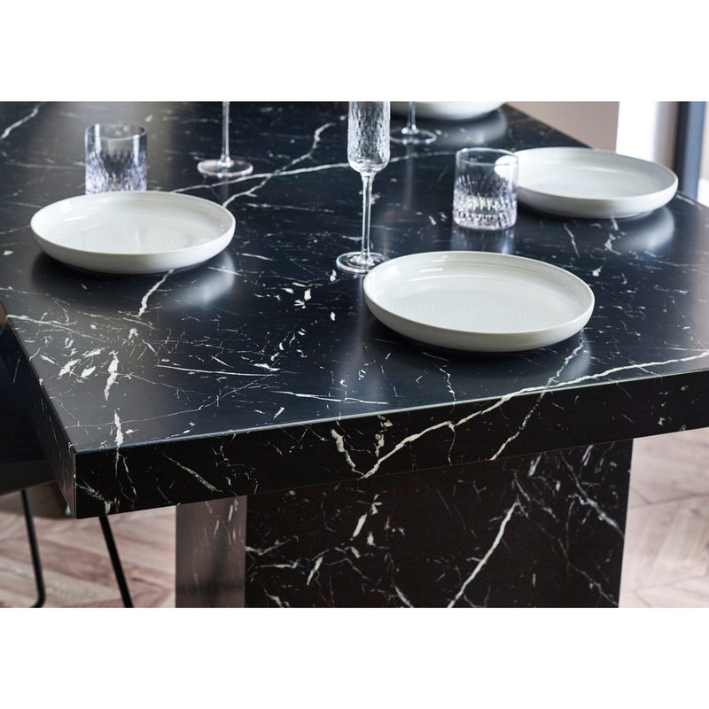 Black marble table with white plates and glasses