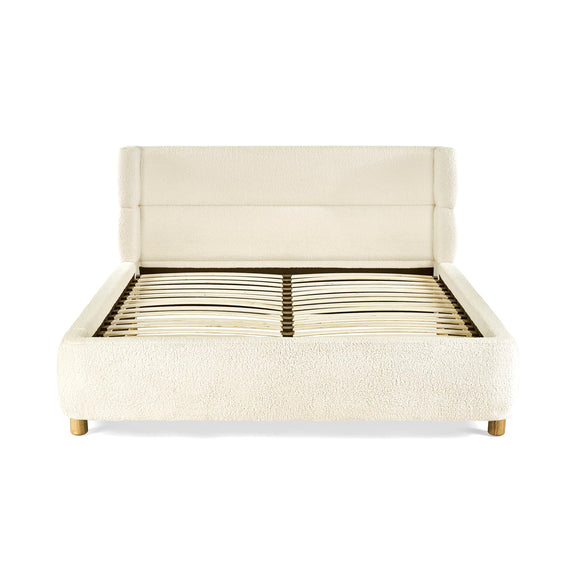 Beige upholstered bed frame on a white background