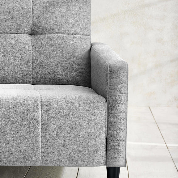 Gray upholstered chair corner on a light wood floor
