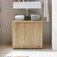 Bathroom with wooden cabinet under a sink, featuring folded towels.