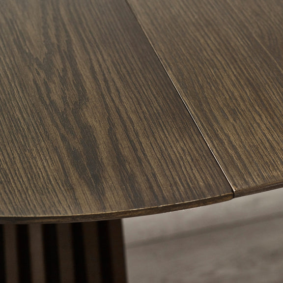 Close-up of a wooden table surface with a visible grain pattern.