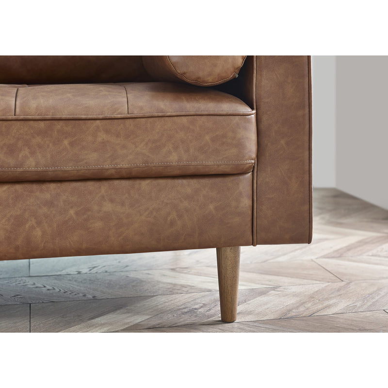 Brown leather sofa corner on a wooden floor