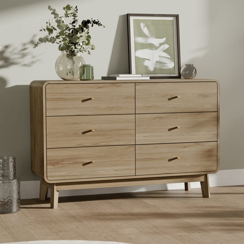 Wooden dresser with decorative items on a wooden floor