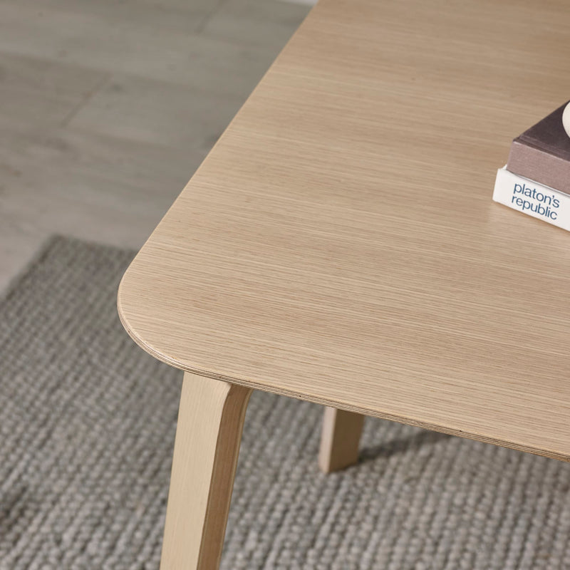 Wooden table with a textured surface on a carpeted floor