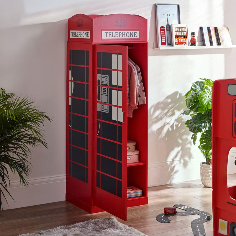 Red telephone booth-shaped bookshelf in a room with plants and a shelf.