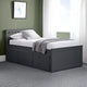Black bed frame with storage drawers in a room with green walls and white curtains.