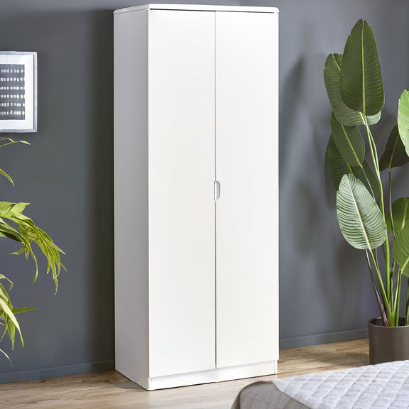 White tall cabinet against a gray wall with plants around