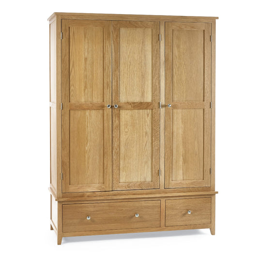 Wooden wardrobe with three doors and two drawers on a white background