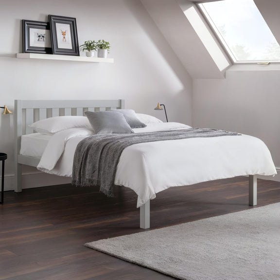 Bedroom with a gray bed frame, white bedding, and a skylight.