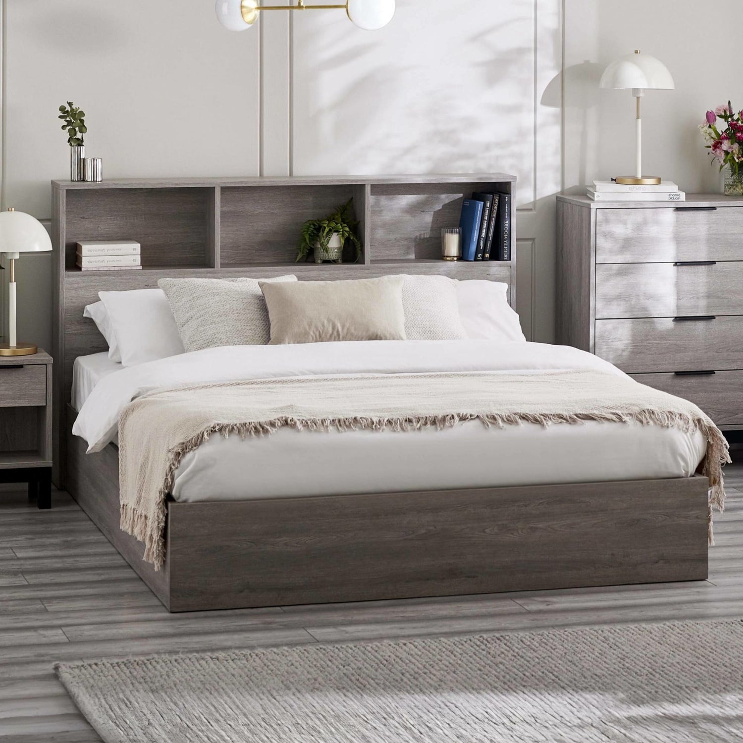 Bedroom with a wooden bed frame, white bedding, and nightstands.