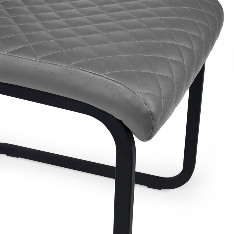 Gray quilted bench with black metal frame on a white background