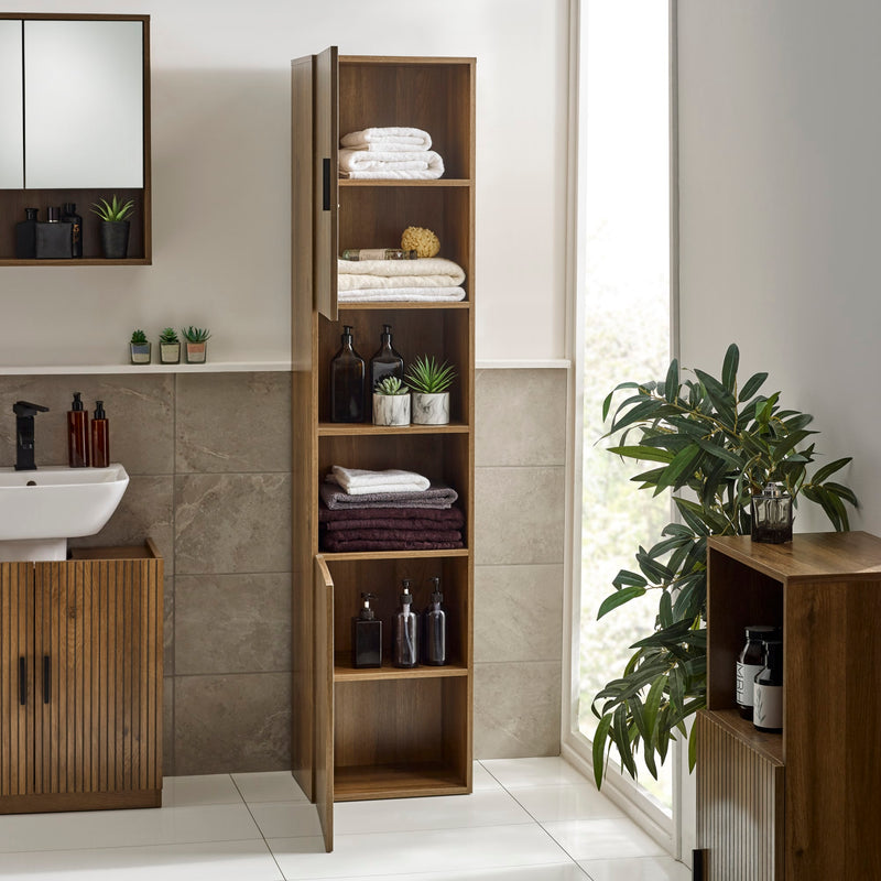 Tall wooden cabinet in a bathroom with shelves and decorative items.