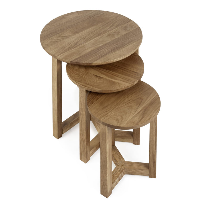Set of three wooden nesting tables on a white background