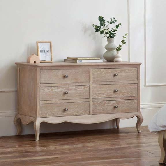 Wooden dresser with decorative items in a room setting