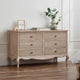 Wooden dresser with decorative items in a room setting