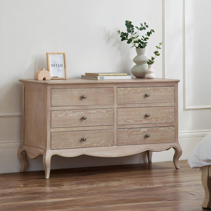 Wooden dresser with decorative items in a room setting