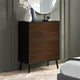 Wooden dresser with three drawers in a bedroom setting.