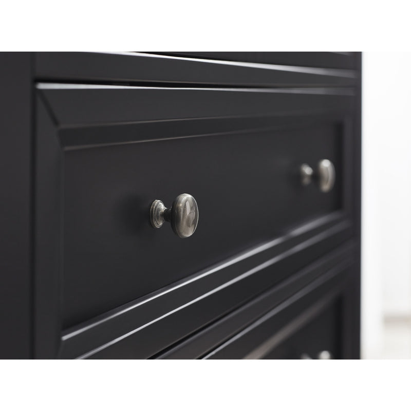 Close-up of a black cabinet with silver knobs on a white background