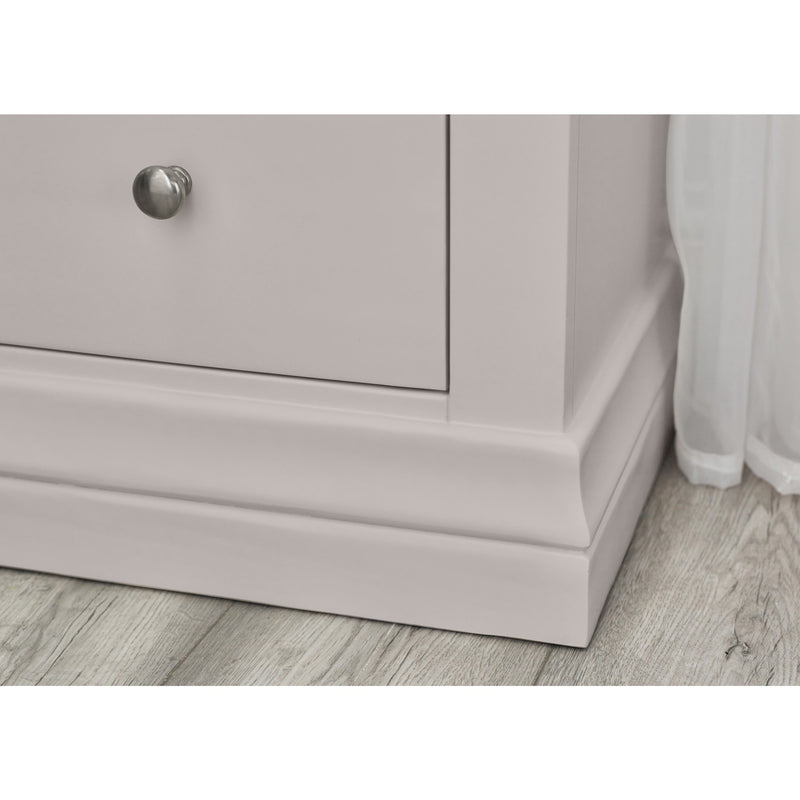 Light purple dresser with a silver knob on a wooden floor.