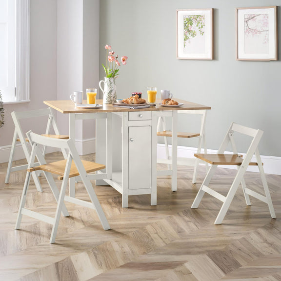 Dining room with a wooden table and white chairs on a wooden floor.