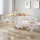 Dining room with a wooden table and white chairs on a wooden floor.