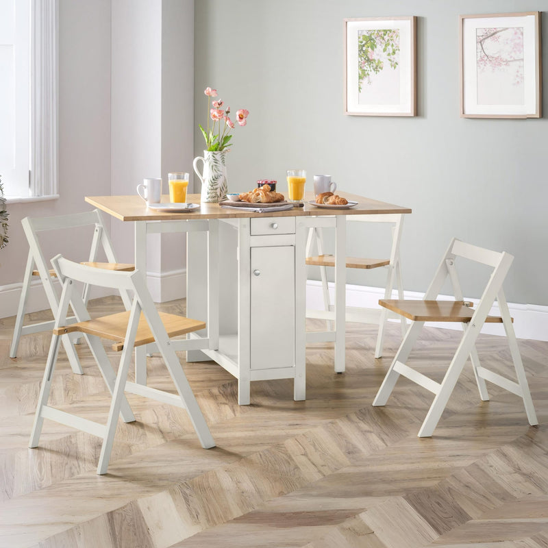 Dining room with a wooden table and white chairs on a wooden floor.