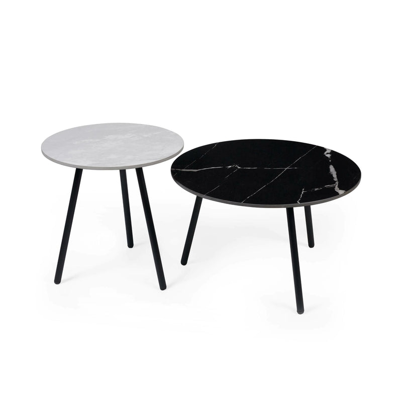 Two round marble coffee tables, one black and one gray, on a white background.