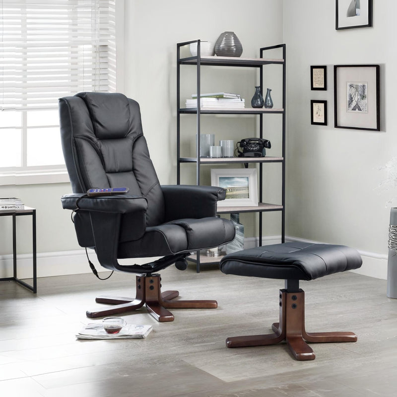 Black recliner chair with ottoman in a room with a bookshelf and framed pictures.