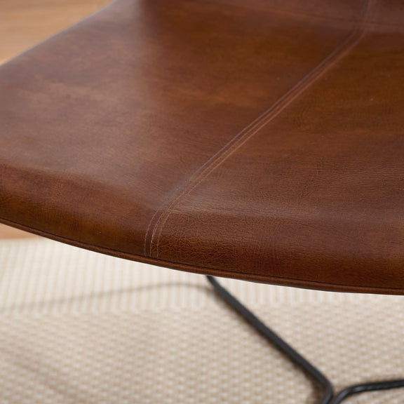 Close-up of a brown leather surface with visible stitching