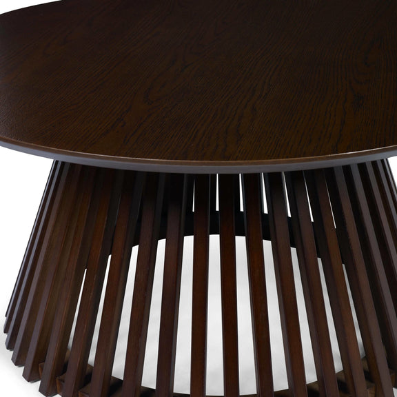 Wooden side table with round top and slatted base on a white background