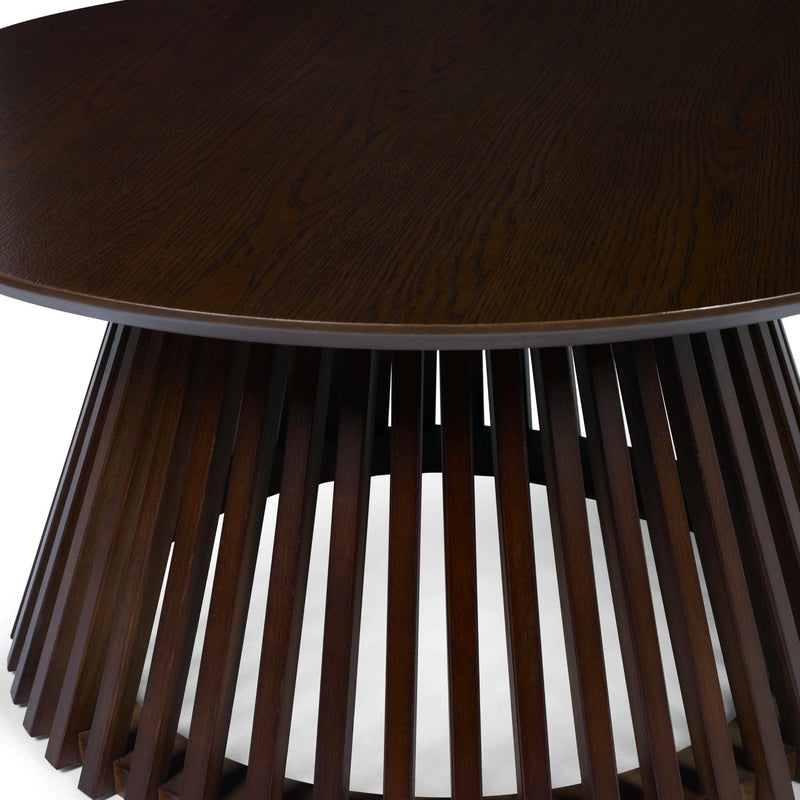 Wooden side table with round top and slatted base on a white background