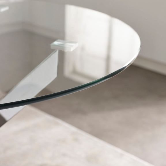 Glass coffee table with white base on a neutral background
