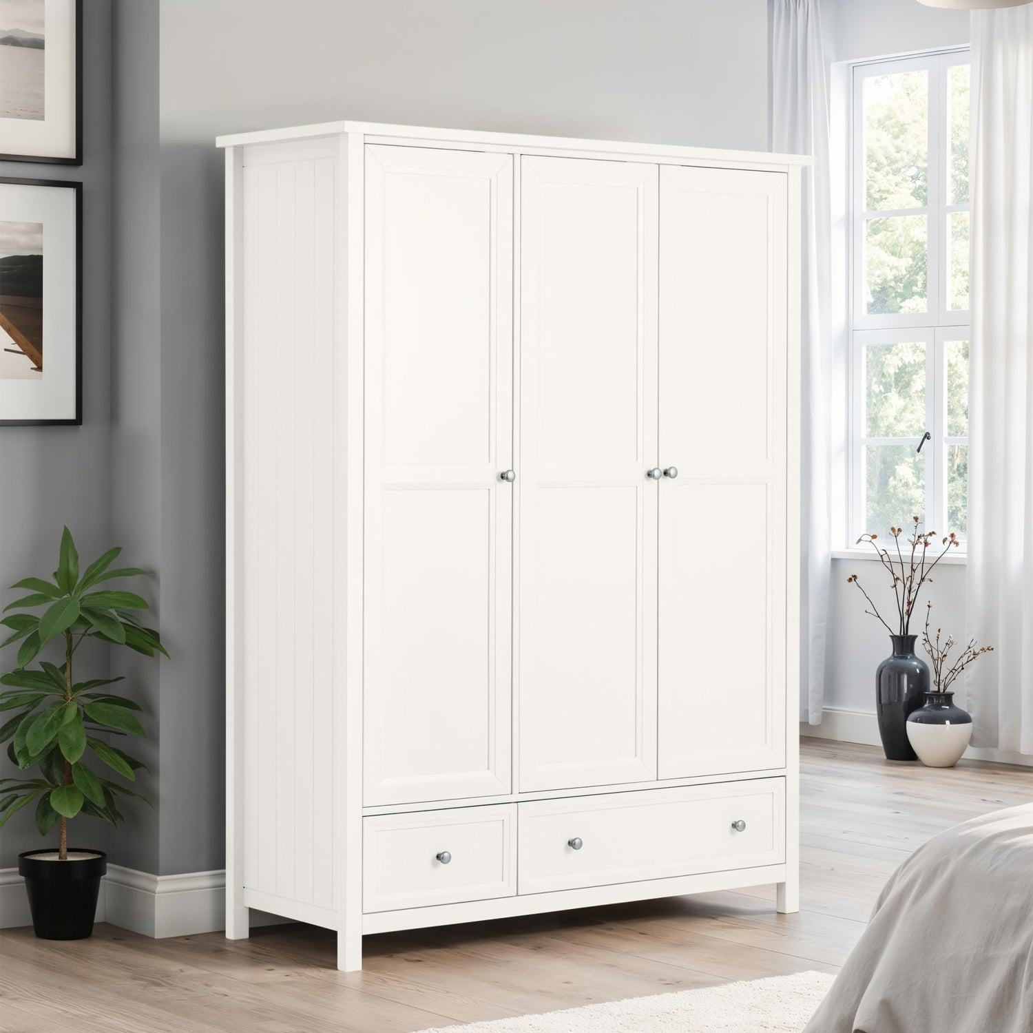 White wardrobe in a bedroom with a plant and window in the background