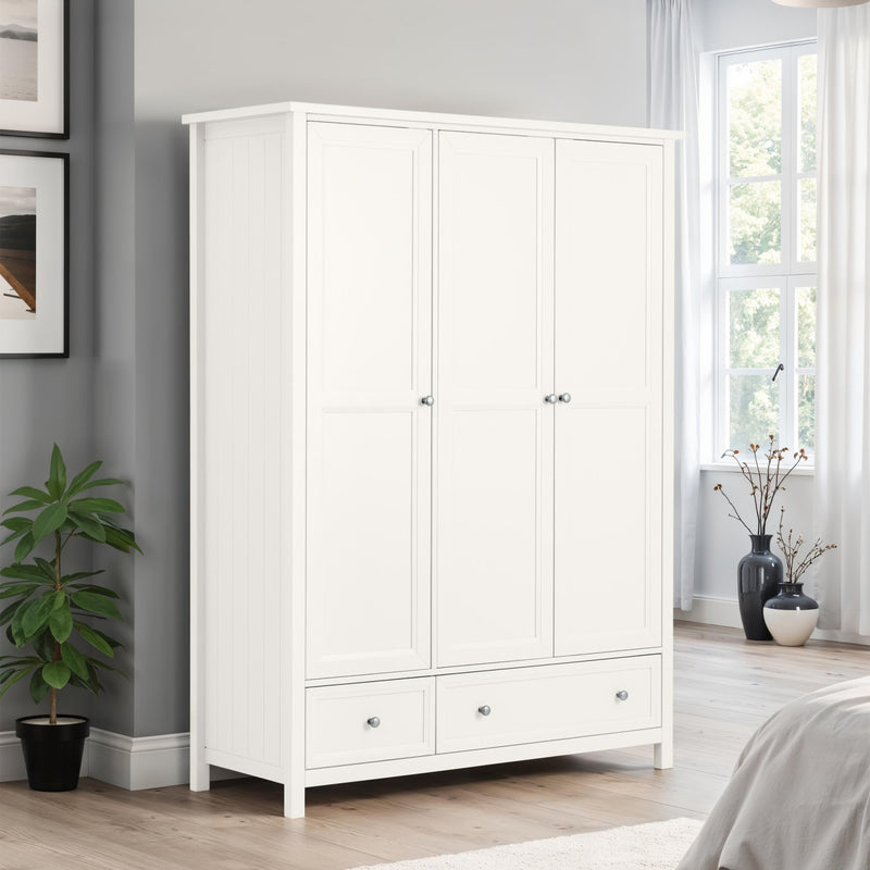 White wardrobe in a bedroom with a plant and window in the background