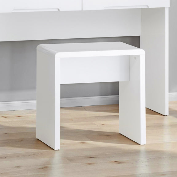 White side table on a wooden floor with a neutral background