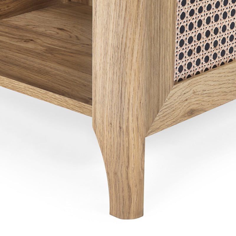 Wooden side table with a patterned cane seat on a white background