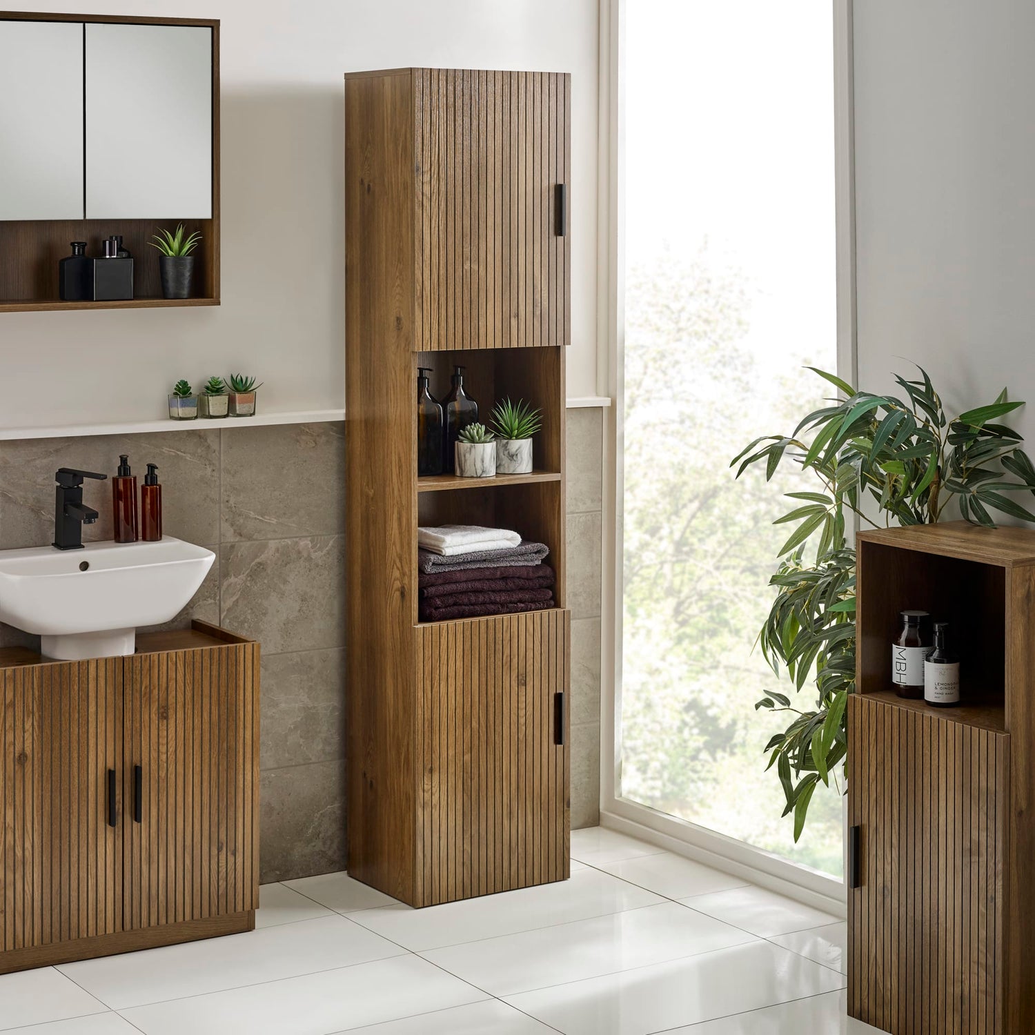 Bathroom with wooden cabinets and a sink, featuring a large window.