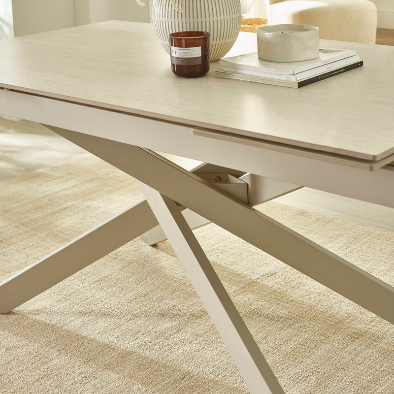 Light wood dining table with a beige carpeted floor