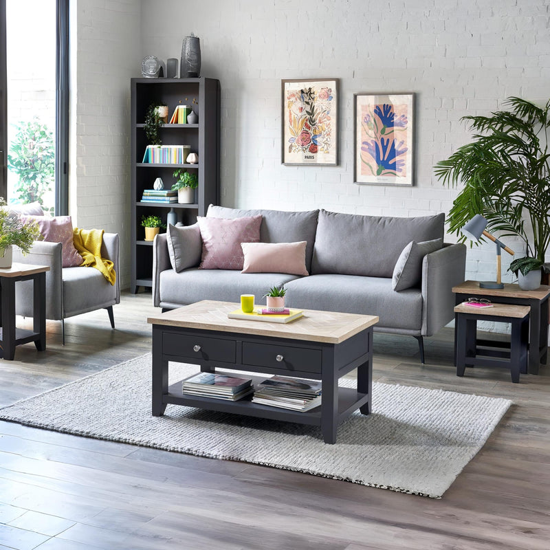 Living room with gray sofa, coffee table, and decorative elements.
