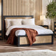 Bedroom with a bed featuring white bedding and a brown blanket, against a wooden paneled wall.