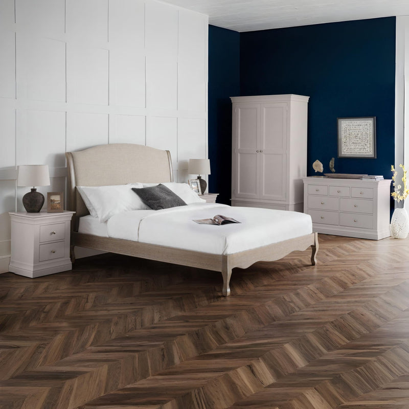 Neatly arranged bedroom with a bed, nightstands, and wardrobe.