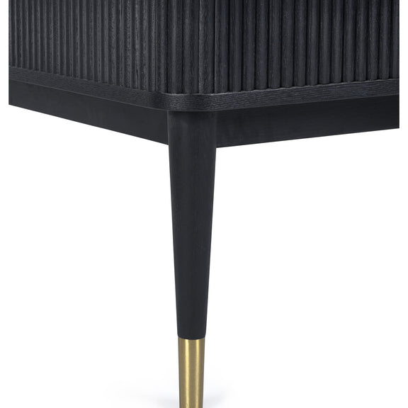 Black side table with gold leg detail on a white background