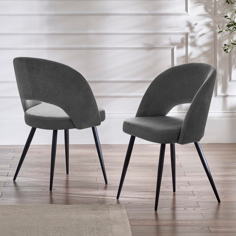 Two gray chairs with black legs on a wooden floor.