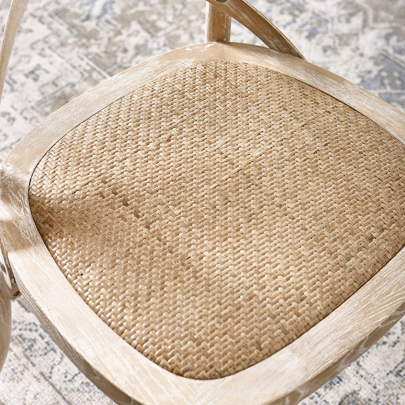 Close-up of a woven chair seat on a textured surface