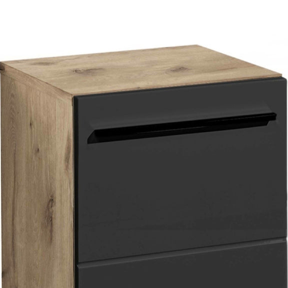 Wooden cabinet with a black drawer on a white background