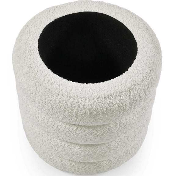 White textured cylindrical object with a black center on a white background